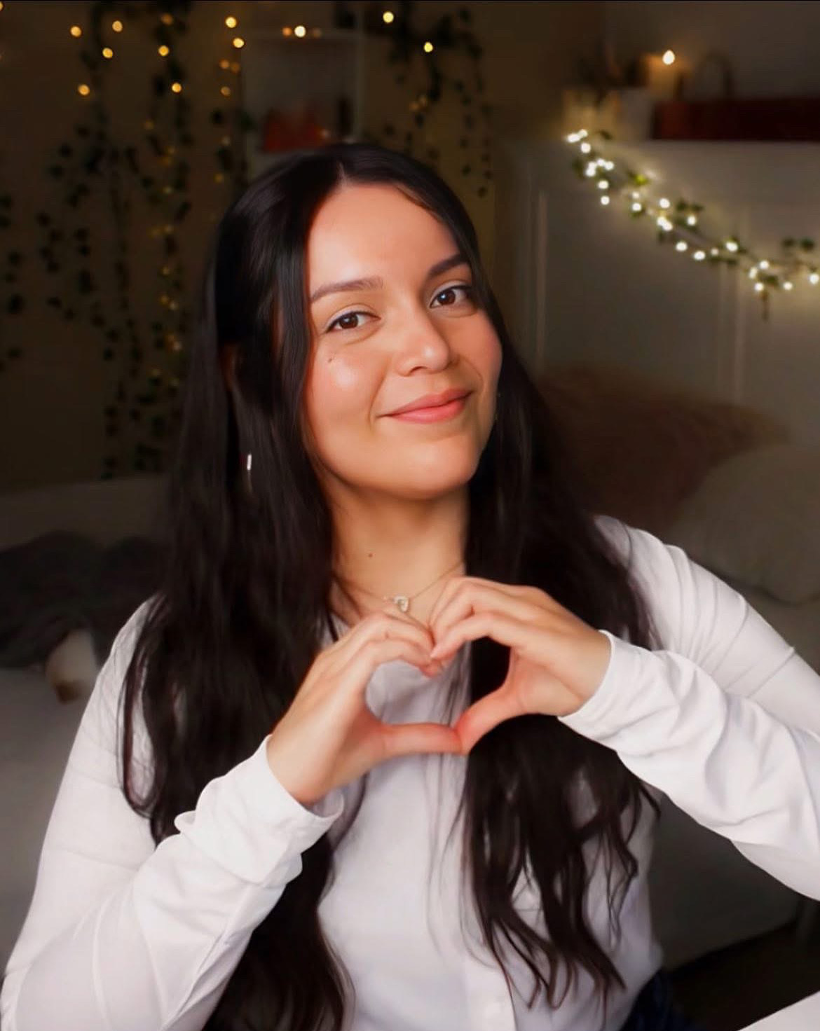 Miroslava Casiano forming a heart with her hands, representing connection, presence, and embodied leadership